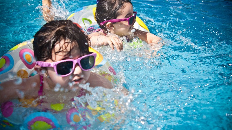 2 children playing in swimming pool 