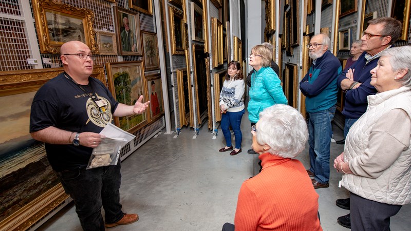 Photograph shows a Behind the Scenes in progress with visitors at GMRC.