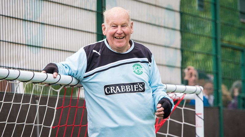 An elderly person playing as a goalkeeper during a Walking Football match