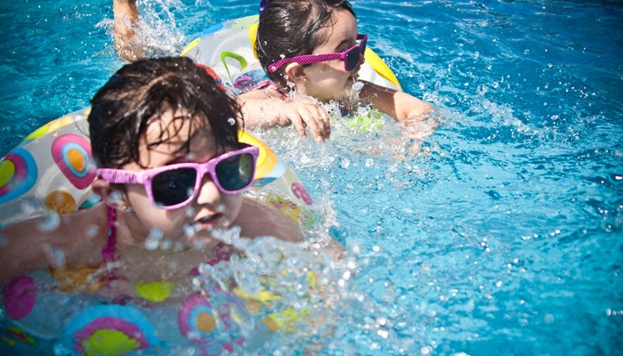 2 children playing in swimming pool 