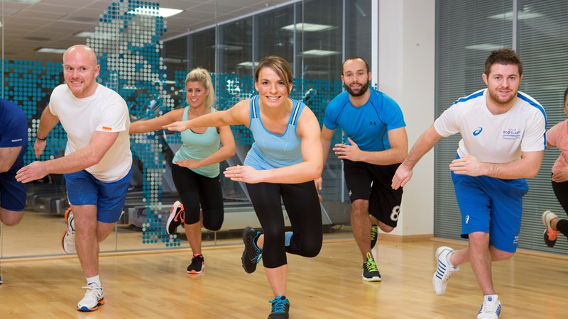 a group of men and women take part in a Glasgow Club class