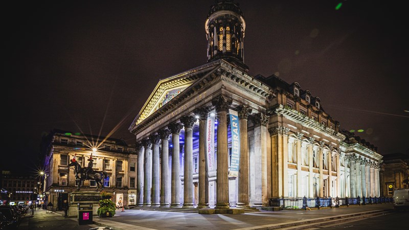 View of the exterior of the Gallery of Modern Art, lit up at night