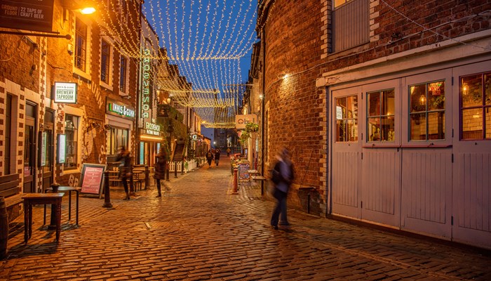 Ashton Lane in Glasgow's west end at night lit up.