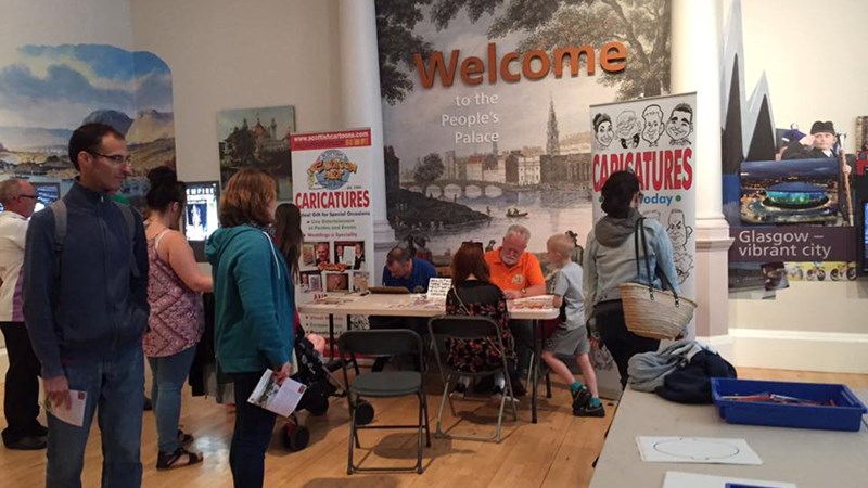 People's Palace Welcome Room. In this instance, there is a man drawing caricatures of visiting children. 