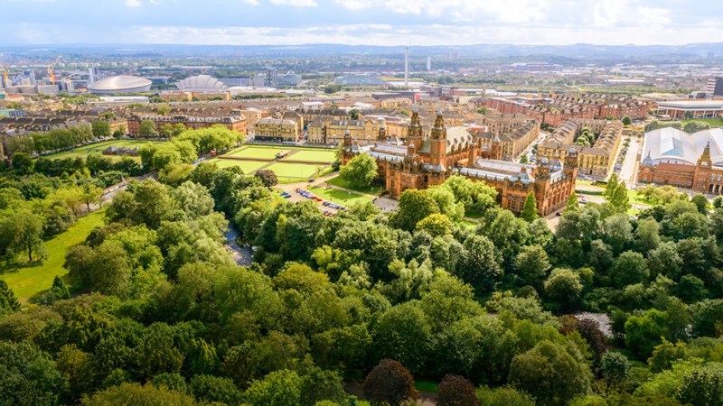 Aerial view of Kelvingrove Park with the trees in full leaf and Kelvingrove Art Gallery and Museum